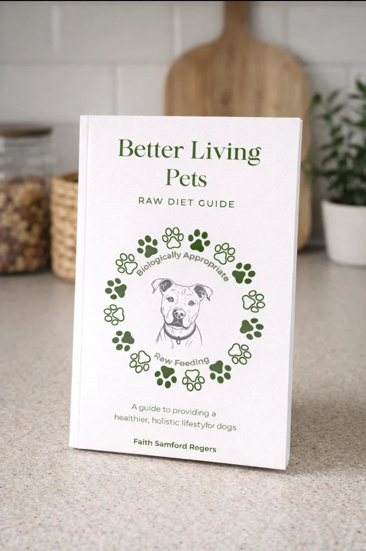 Book titled 'Better Living Pets Raw Diet Guide' on a surface with a kitchen background